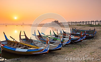 Wooden boat in Ubein Bridge at sunrise, Mandalay, Myanmar Stock Photo