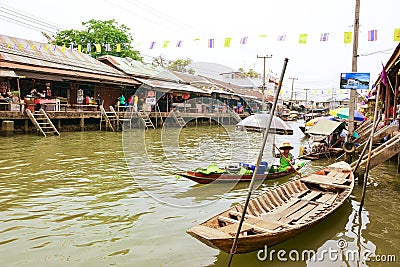 Wooden boats busy ferrying people at Amphawa floating market Editorial Stock Photo