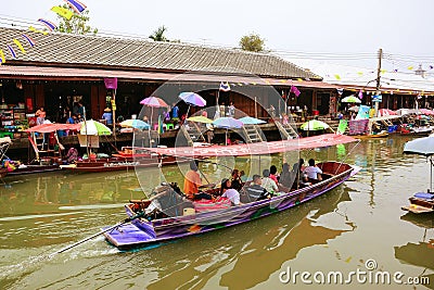 Wooden boats busy ferrying people at Amphawa floating market Editorial Stock Photo