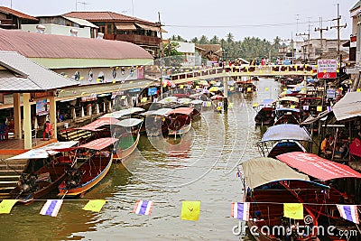 Wooden boats busy ferrying people at Amphawa floating market Editorial Stock Photo