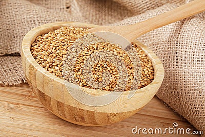 Wooden bowl filled with healthy and delicious Roasted Flax Seeds Stock Photo