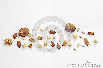 Wooden bowl with mixed nuts on white table top view. Healthy food and snack. Walnut, pistachios, almonds, hazelnuts Stock Photo