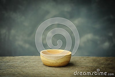 Wooden bowl on old rusted wood background Stock Photo