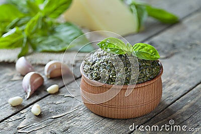 Wooden bowl of traditional Italian sauce pesto Stock Photo