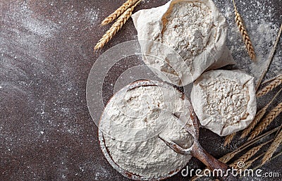 Wooden bowl of wheat flour on kitchen background top view. Ingredient for baking Stock Photo