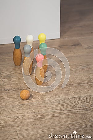 Wooden bowling toy game with a ball on a domestic indoor hardwood floor Stock Photo