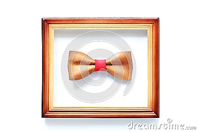 Wooden bowtie in wood frame isolated on white. Leadership, unique, independence, initiative, think different, success Stock Photo