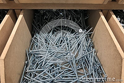 Wooden box filled with long screws. Reparing equipment Stock Photo