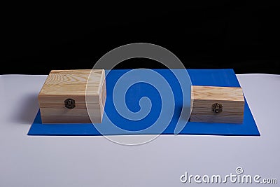 Wooden boxes on black background and blue mat Stock Photo