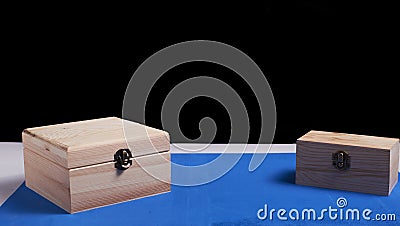 Wooden boxes on black background and blue mat Stock Photo