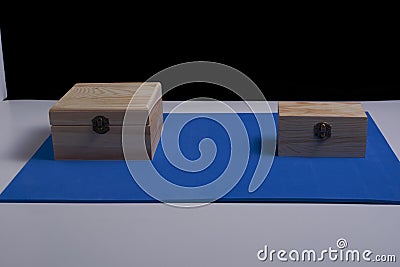 Wooden boxes on black background and blue mat Stock Photo
