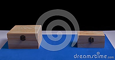 Wooden boxes on black background and blue mat Stock Photo