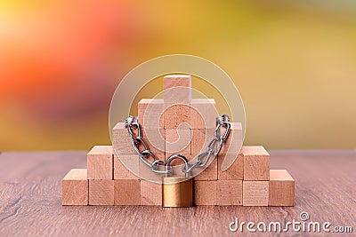 Wooden bricks tied with a chain. Concept: stability protection Stock Photo