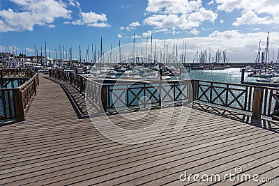 Wooden bridge at the boat harbor of Marina Rubicon in Playa Blanca. Lanzarote Editorial Stock Photo