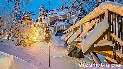 Wooden bridge with house in the night with light in the snow in Saxon Switzerland National Park, Elbe Sandstone Mountains at the B Stock Photo