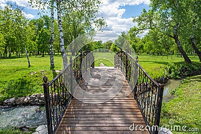 Wooden bridge with metal railings Stock Photo