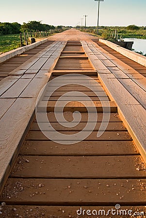 Wooden bridge over marsh in Pantanal wetland region, Brazil Stock Photo