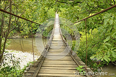 Wooden bridge over a river Stock Photo