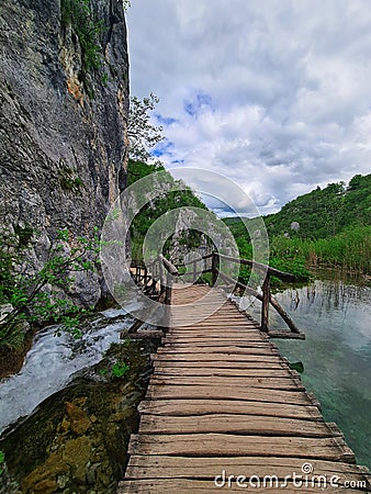 A wooden bridge over the small but fast torrent Stock Photo