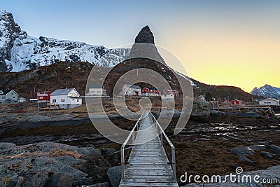 Wooden bridge used as leading lines towards the famous mountain and houses in Reine Stock Photo