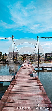 a wooden bridge used as a walkway across a drain Stock Photo