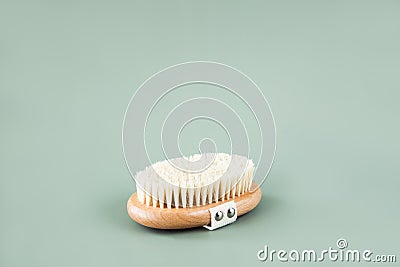Wooden brush for anti-cellulite body massage, scrub made of eco friendly bamboo fiber. Body care at home. Stock Photo