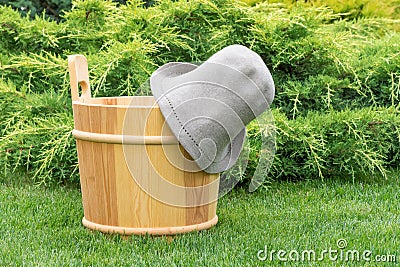 Wooden bucket and felt hat for the sauna. Stock Photo