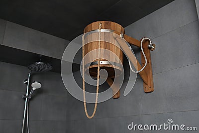 Wooden bucket for russian bathhouse. in the shower Cold water hydrotherapy after sauna. Rustic lifestyle Stock Photo