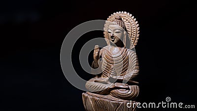 WOODEN BUDDHA STATUE IN LUMINANCE LIGHTING Stock Photo