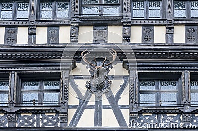 Wooden building facade with hunting trophy sculpture Stock Photo