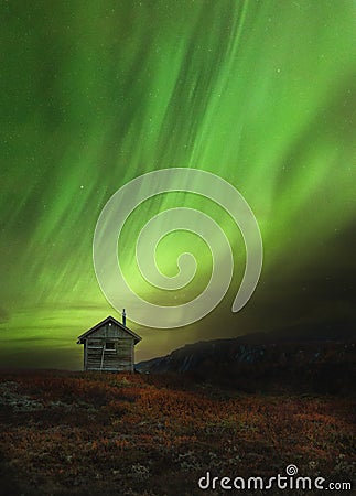 Wooden cabin in norwegian mountains called Sylan. Beautiful Aurora Borealis Stock Photo