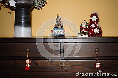 Wooden cabinet with Christmas decorations and christmas muggle carousel Stock Photo