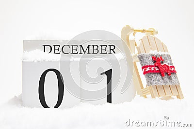 Wooden calendar for December, 1 st day of the winter month. The symbols of winter are snow and sleigh. Concept of holidays, Stock Photo