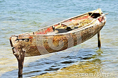 Wooden canoe moored on posts Stock Photo