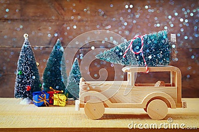 Wooden car carrying a christmas tree. Glitter overlay Stock Photo