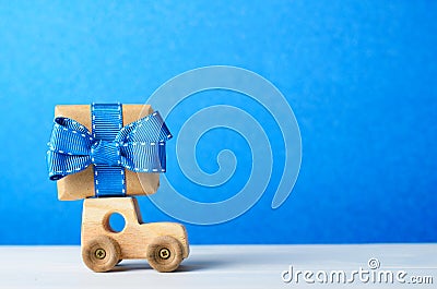 Wooden Car Carrying a Gift Box, Birthday, Surprise, Father`s Day Concept Stock Photo