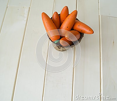 A wooden carrot is a toy.Children`s toy of orange color. Stock Photo