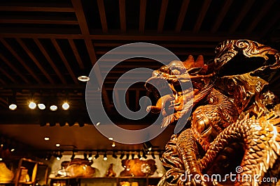 Wooden carving dragon under latticed ceiling in shop Editorial Stock Photo