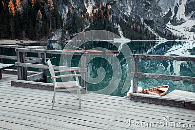 Wooden chair on the Alpine mountain lake. Lago di Braies Stock Photo