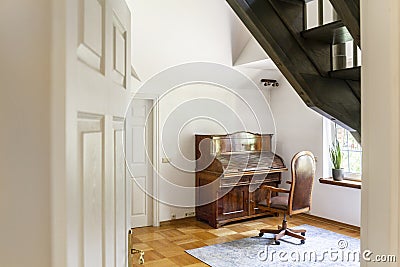 Wooden chair at classic piano in white interior of elegant house Stock Photo