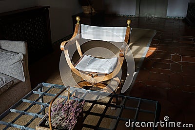 Wooden chair with curved backrest placed in a sunlit room Stock Photo