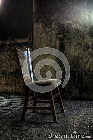 Wooden chair in derelict house Stock Photo