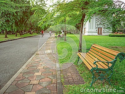 Wooden chair in the Green park and people relax in the park Stock Photo