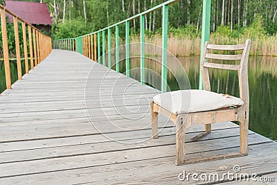 Wooden chair on the pier Stock Photo