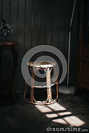 A wooden chair solid light strikes a chair creating a sharp shadow in the sunshine cozy homely atmosphere. Stock Photo