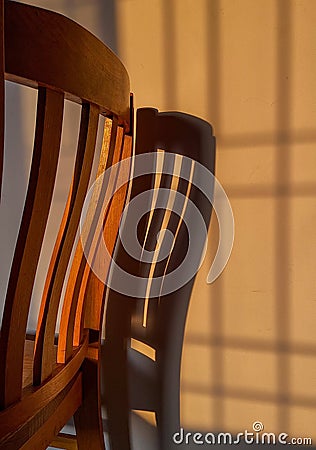 wooden chair with suns rays on it.sunset time. Stock Photo