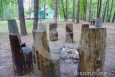 Wooden chairs around a fire, tourist recreation area Editorial Stock Photo