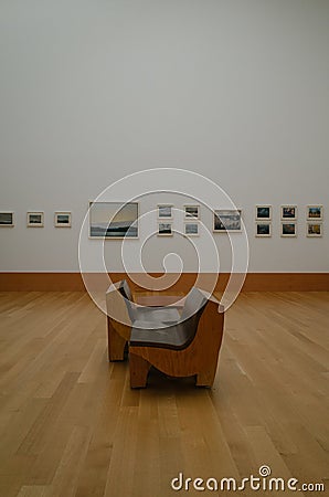 Wooden chairs in the waiting room of a gallery Editorial Stock Photo
