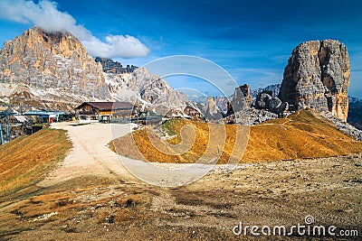 Wooden chalet and Cinque Torri rock formations in the Dolomites Stock Photo