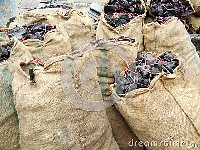 Wooden charcoal packing in hemp sacks Stock Photo